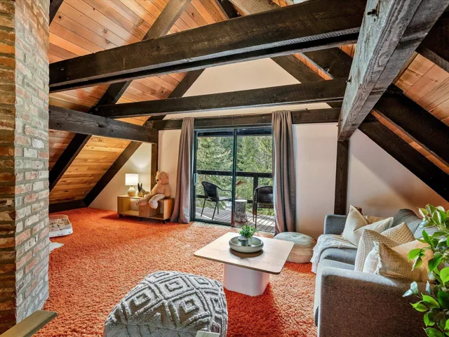 Interior space with vaulted ceiling with beams, carpet floors, and wood ceiling