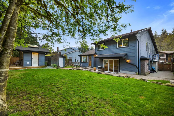 Rear view of property featuring a patio and a storage shed