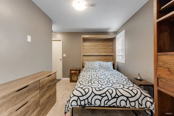 Bedroom with baseboards and a textured ceiling