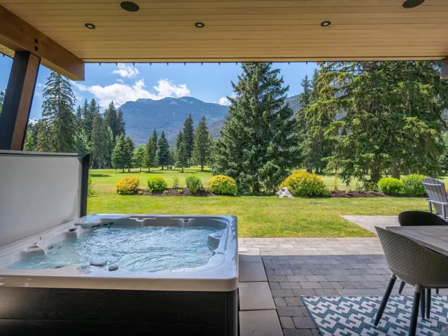 View of patio / terrace featuring a hot tub and a mountain view