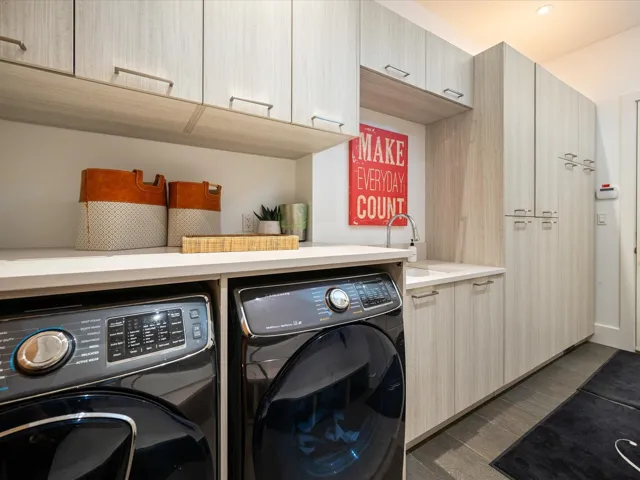 Washroom with cabinet space and wood finished floors