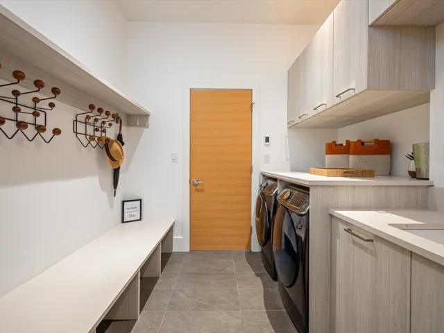 Laundry area featuring washer and dryer, cabinet space, and light tile patterned floors