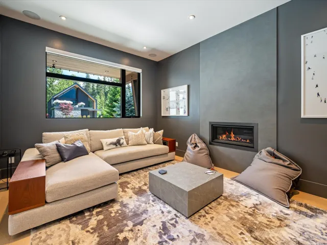 Living area featuring wood finished floors, a large fireplace, and recessed lighting