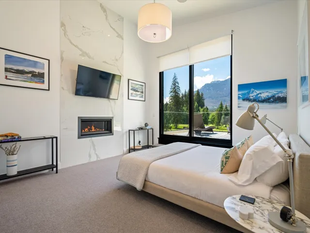 Bedroom with carpet floors, a high end fireplace, and access to exterior