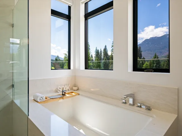 Bathroom featuring a garden tub, a mountain view, and a walk in shower