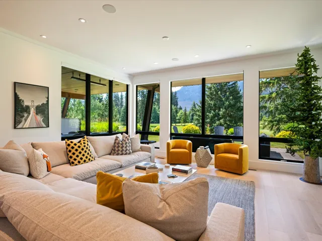 Living room with wood finished floors, recessed lighting, and ornamental molding