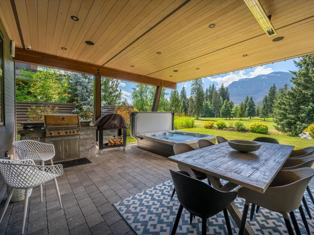 View of patio / terrace with outdoor dining area, a mountain view, and exterior kitchen