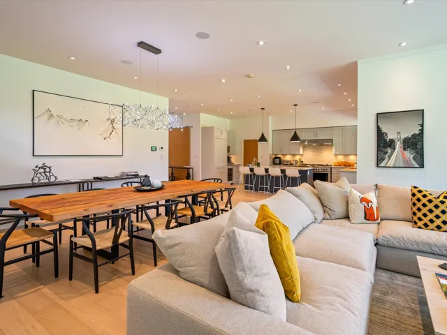 Living area with light wood-type flooring, recessed lighting, and a chandelier