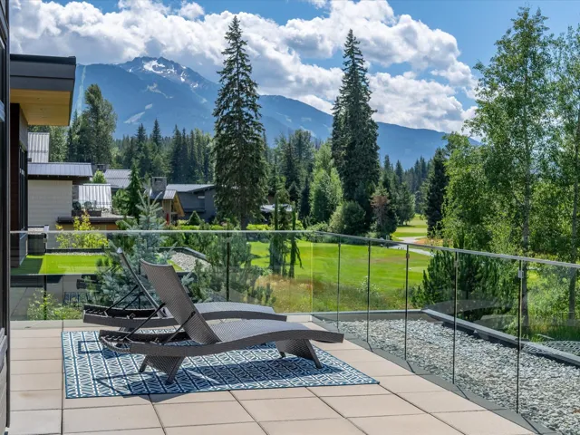 View of property's community featuring a mountain view, a balcony, and view of wooded area