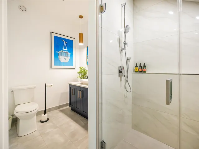 Full bath featuring vanity, a shower stall, and light tile patterned floors