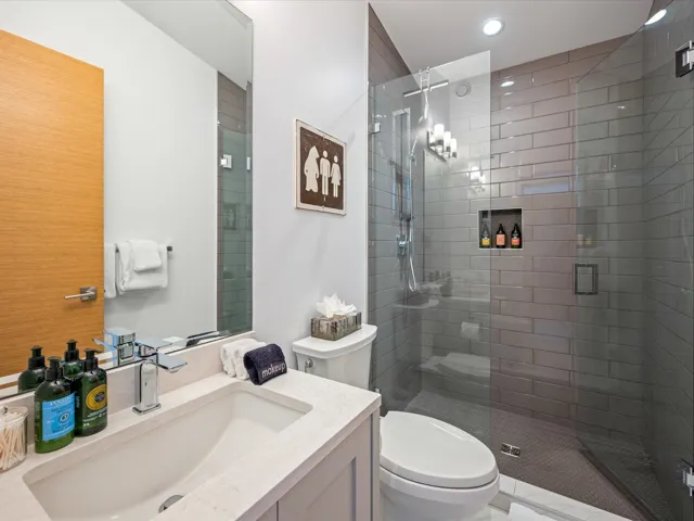 Full bathroom with vanity and a stall shower