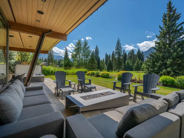 View of patio / terrace featuring an outdoor living space with a fire pit and a mountain view