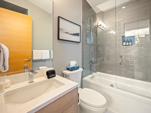 Full bathroom with bath / shower combo with glass door and vanity