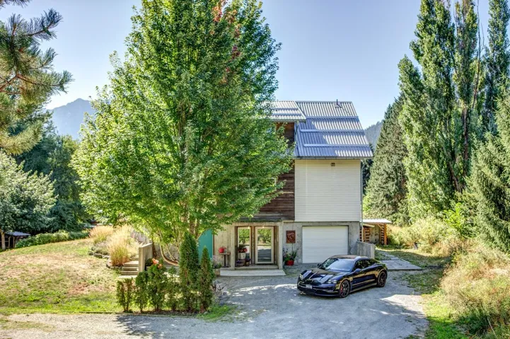 View of front of home featuring asphalt driveway and an attached garage