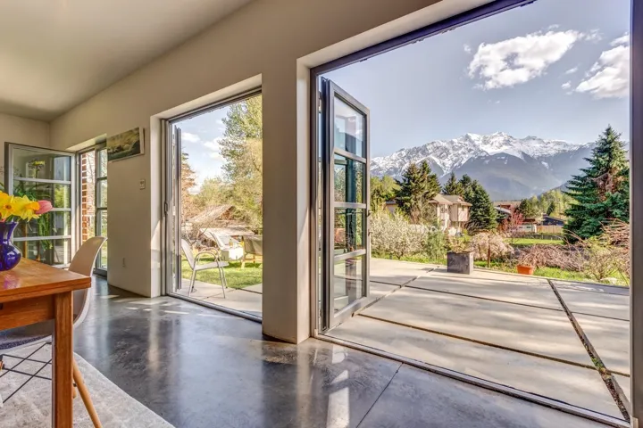 Doorway featuring a mountain view and finished concrete flooring
