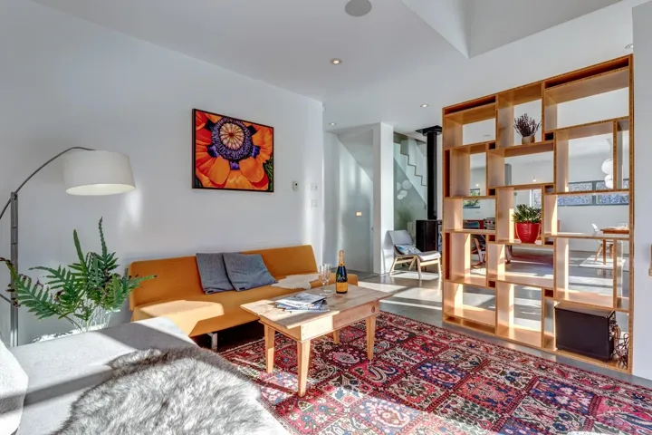 Living room featuring a wood stove and recessed lighting