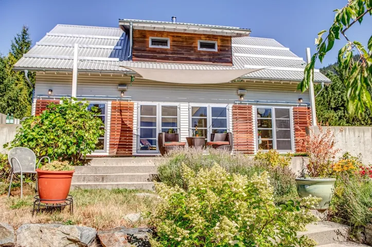 Rear view of house featuring a metal roof