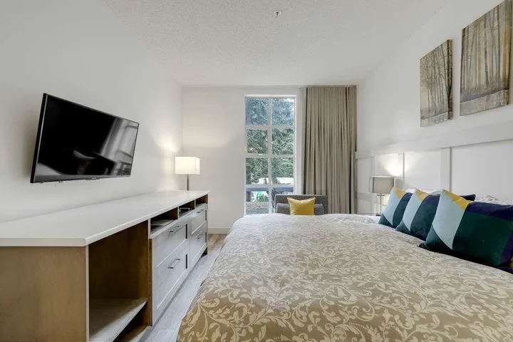 Bedroom with a textured ceiling and light wood finished floors