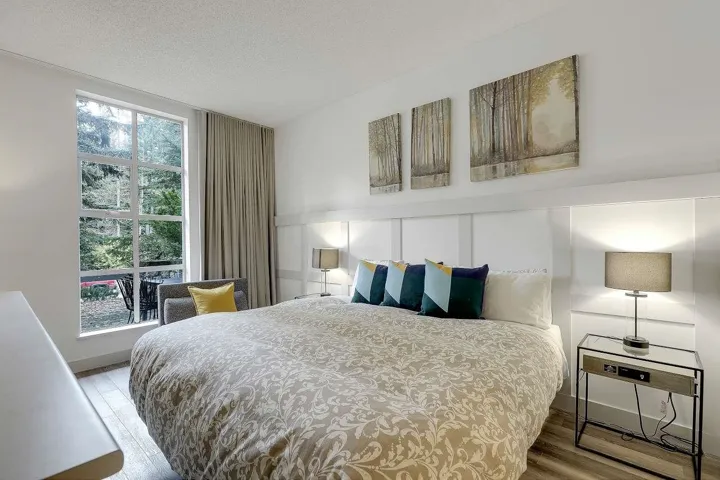 Bedroom with light wood finished floors and a textured ceiling