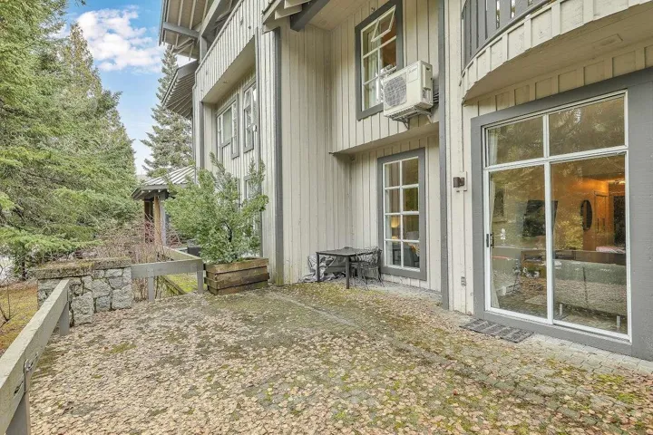View of home's exterior featuring board and batten siding and a gate