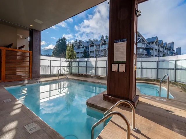 Community pool featuring a patio area and a fenced backyard