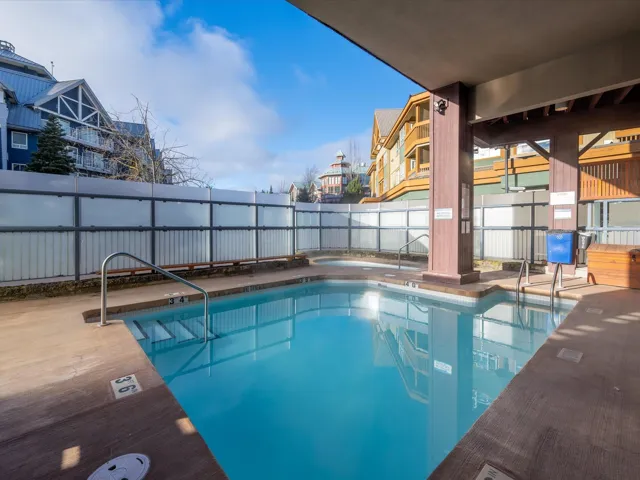 Community pool with a patio