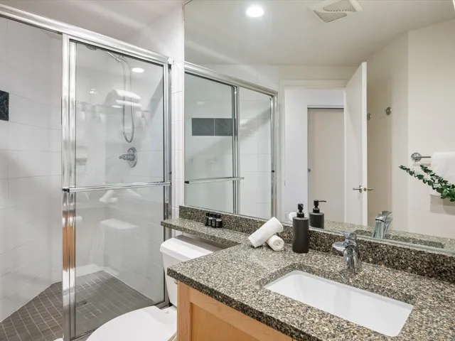 Bathroom with vanity, a stall shower, and recessed lighting
