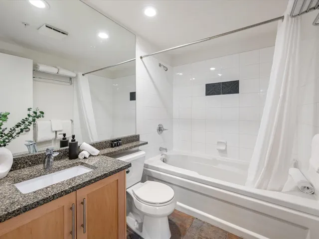 Full bathroom with vanity, shower / tub combo, and recessed lighting