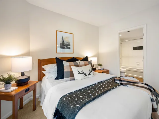 Bedroom featuring carpet floors and ensuite bath
