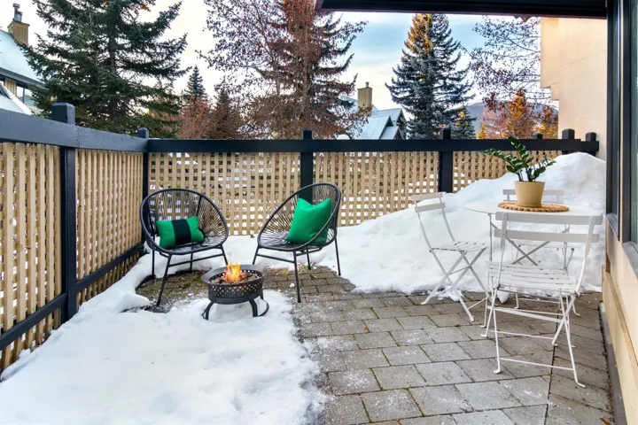 Snow covered patio featuring a fire pit