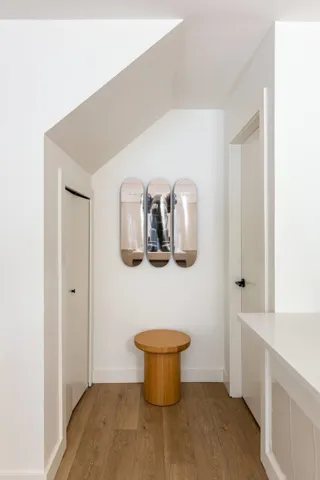 Corridor with vaulted ceiling and light wood finished floors
