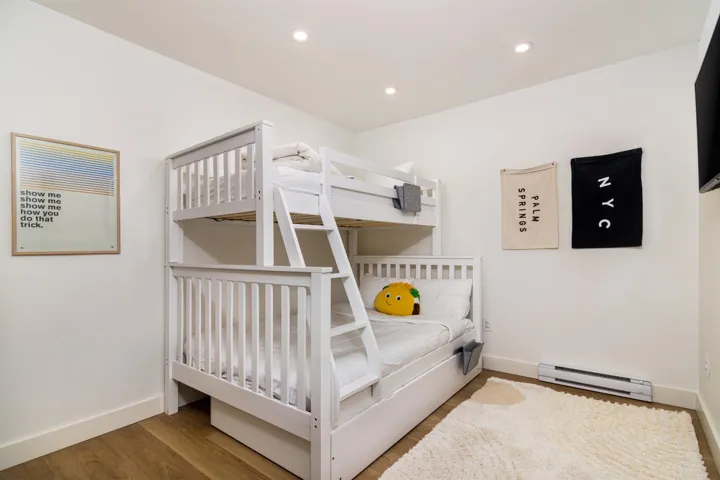 Bedroom featuring a baseboard radiator, recessed lighting, and wood finished floors