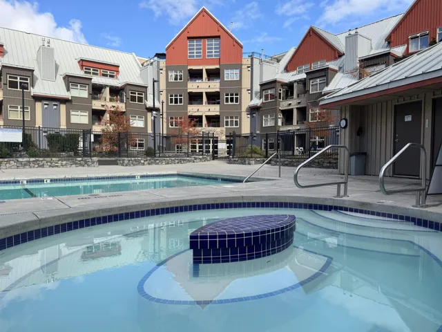 Community pool with a community hot tub and a patio