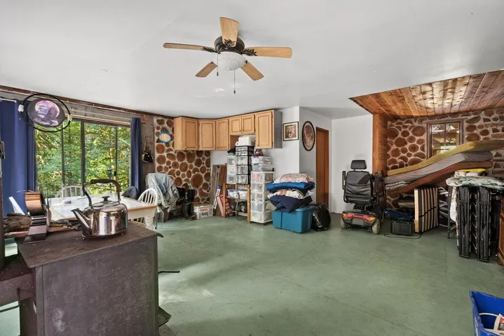 Living room with finished concrete floors and a ceiling fan