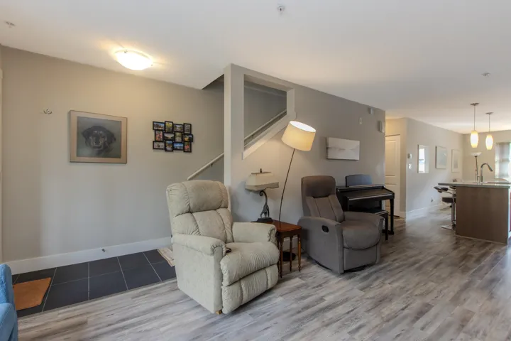 Living area with stairway and wood finished floors