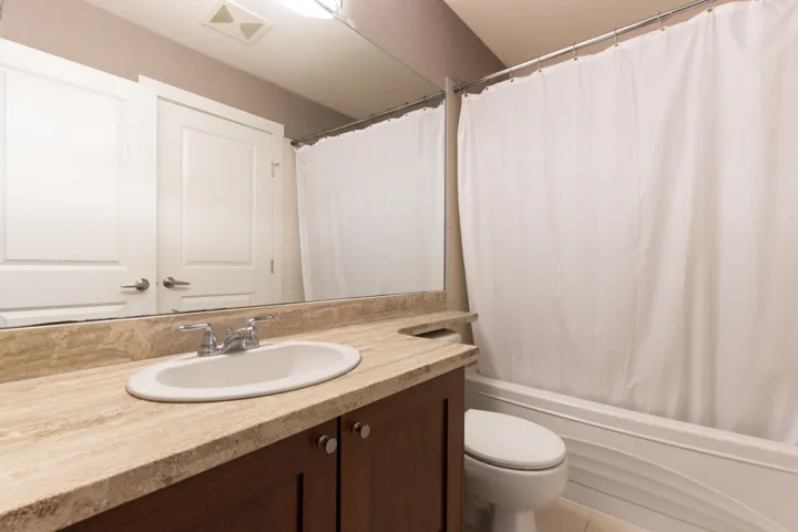 Full bath with vanity and shower / bath combo with shower curtain