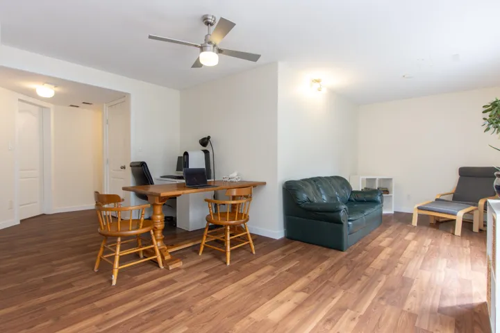 Home office with light wood-style flooring and a ceiling fan