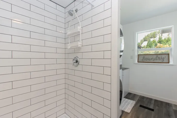 Full bathroom with a shower stall and wood finished floors