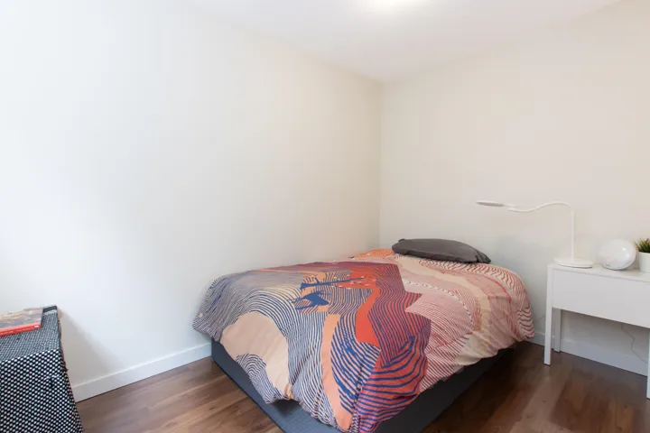 Bedroom featuring wood finished floors and baseboards