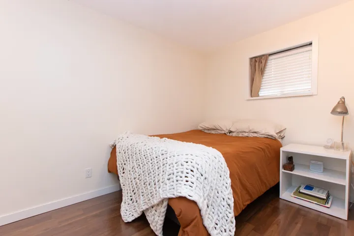 Bedroom with wood finished floors and baseboards