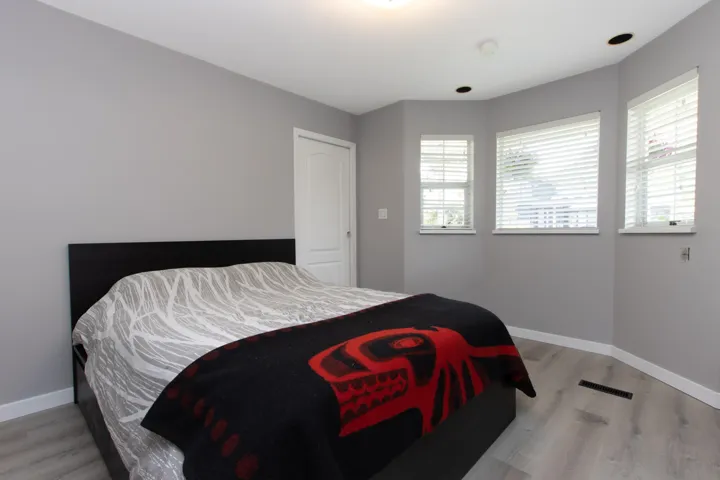 Bedroom with wood finished floors and baseboards