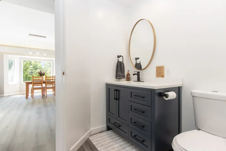 Half bathroom with vanity and wood finished floors