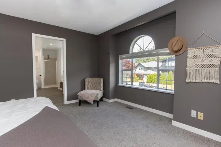 Bedroom featuring carpet floors and ensuite bath