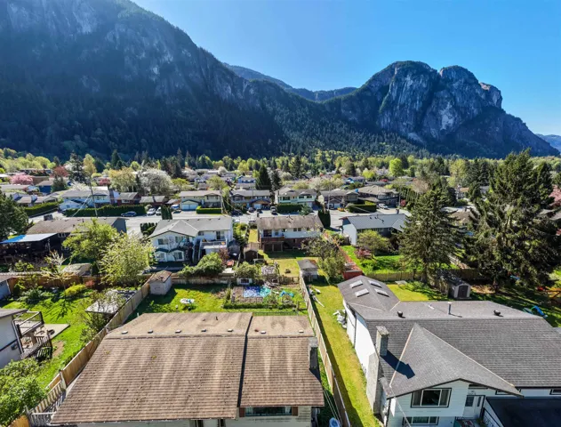 Residential neighborhood with diverse home styles, set against a backdrop of prominent mountains and extensive natural scenery