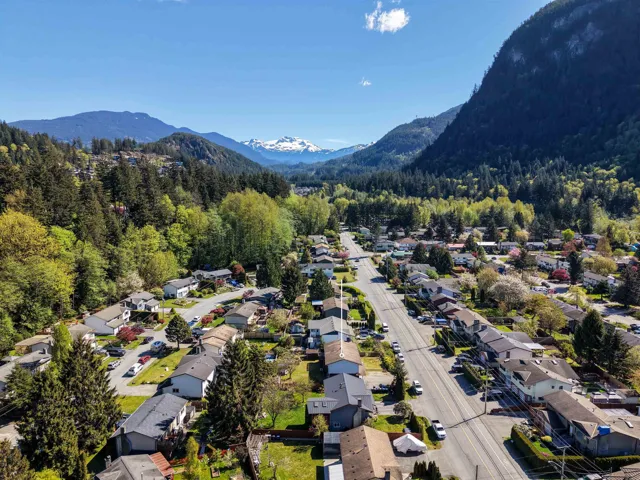 Residential neighborhood featuring mature trees and mountain scenery