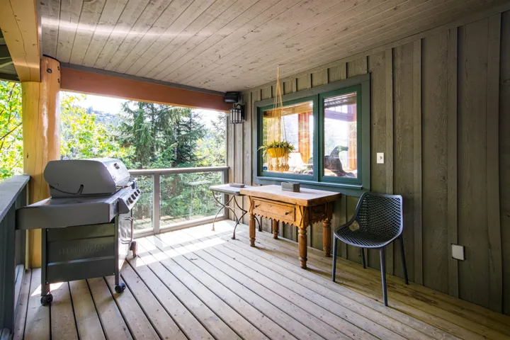 Wooden terrace featuring area for grilling