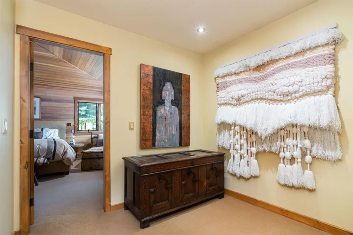 Hallway featuring light carpet, baseboards, and recessed lighting