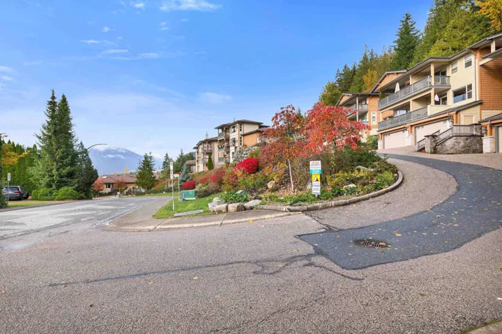 Townhome community with multi-level dwellings, each featuring individual garages and private balconies