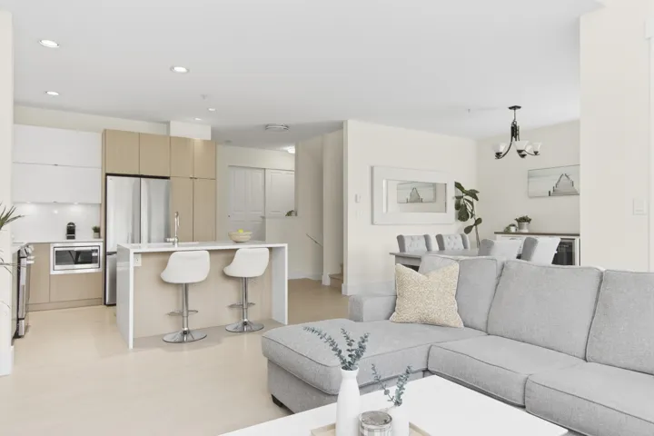 Open-concept living area with light wood-finish flooring