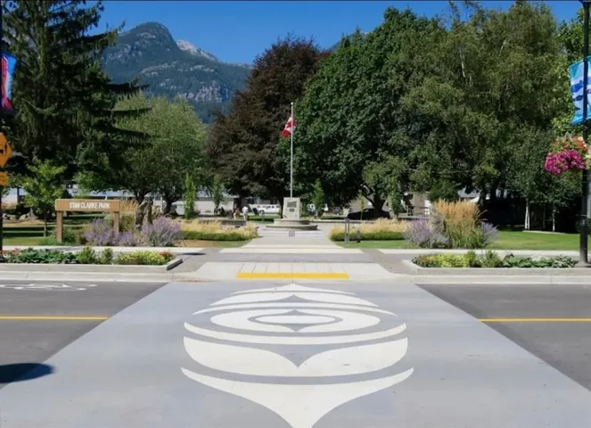 View of asphalt street with a mountain view, curbs, and sidewalks